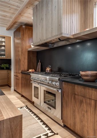 a kitchen with granite countertop a stove and a sink