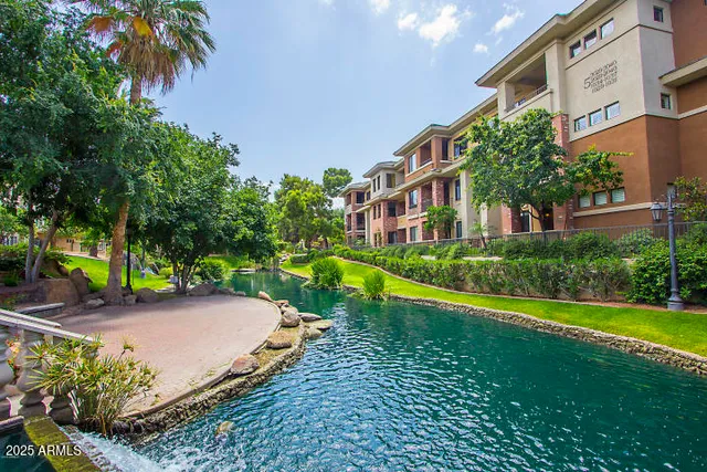a living room with furniture kitchen view and a large window