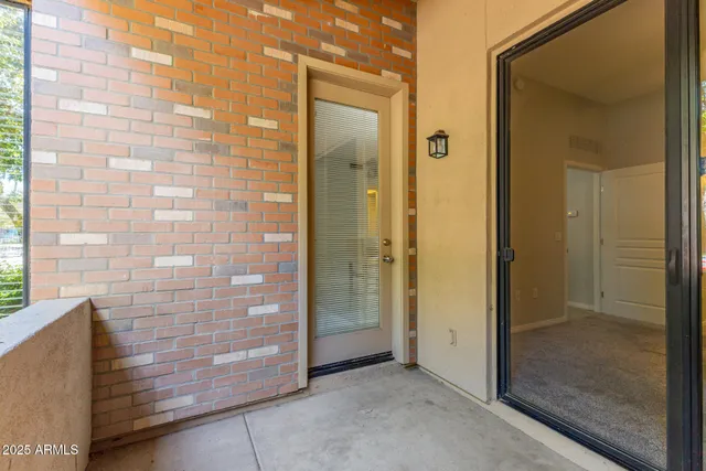 a living room with furniture a flat screen tv and floor to ceiling window