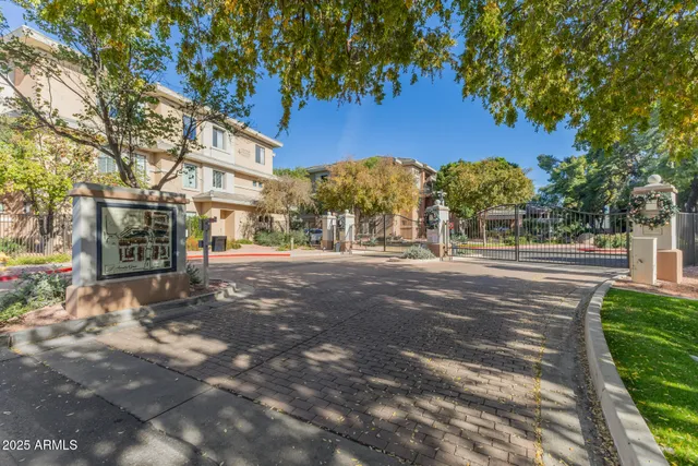 a view of a street with a building and trees in the background