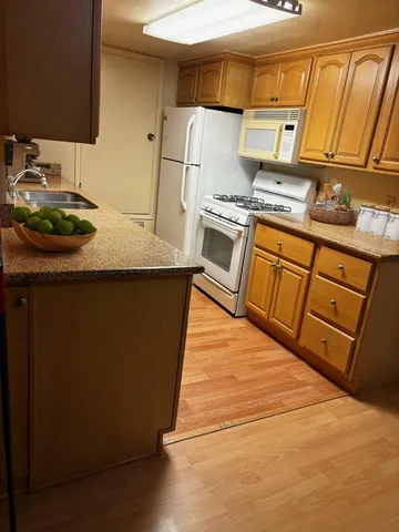 a kitchen with stainless steel appliances a stove a sink and a refrigerator