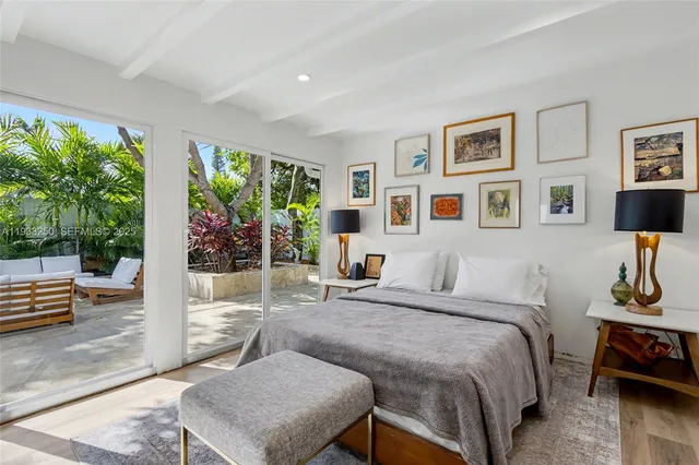 a bedroom with furniture and a potted plant