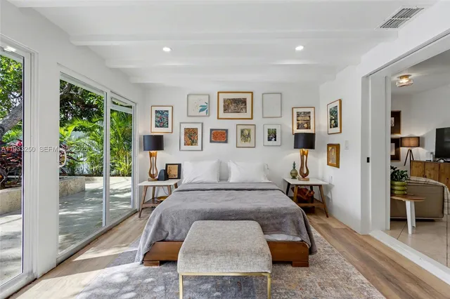 a bedroom with a large bed and a large window