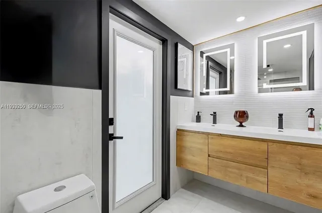 a bathroom with a tub a sink and mirror