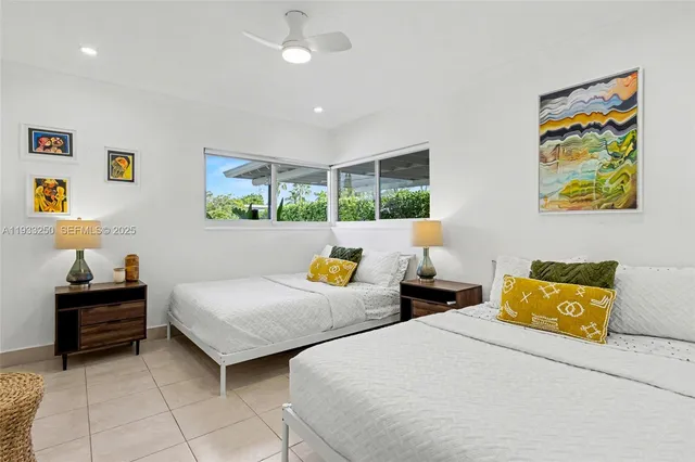 a bedroom with two beds and painted walls