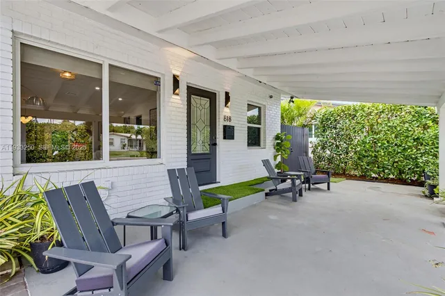 a view of a patio with table and chairs and potted plants