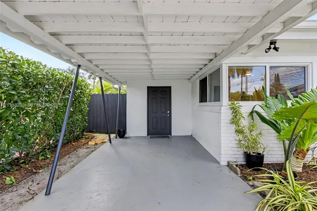 a view of a porch with furniture and a yard