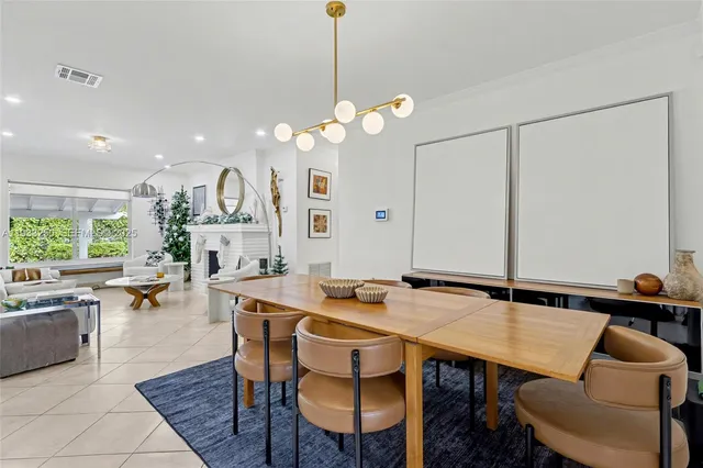 a view of a dining room with furniture and a chandelier