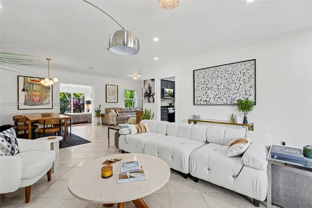 a living room with furniture and kitchen view