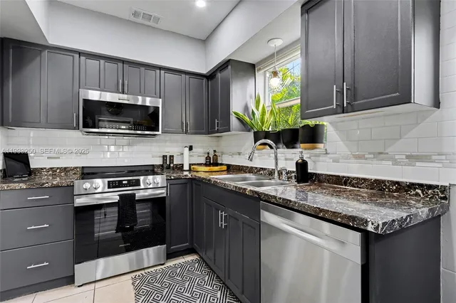 a kitchen with a sink stove and microwave