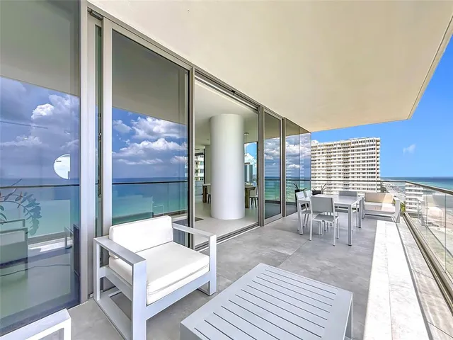 a view of a dining room with furniture and window