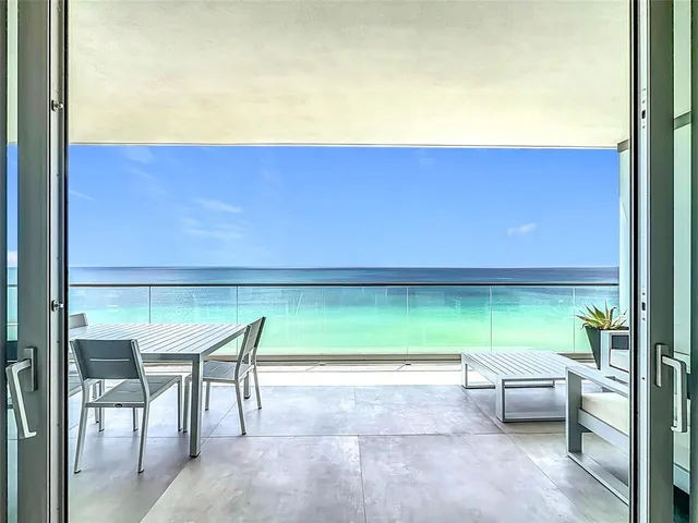 a view of a chairs and table in the patio