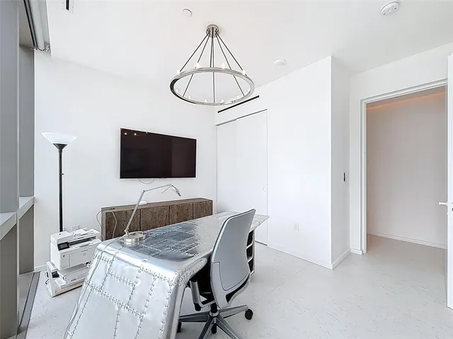 a bedroom with a bed and ceiling fan