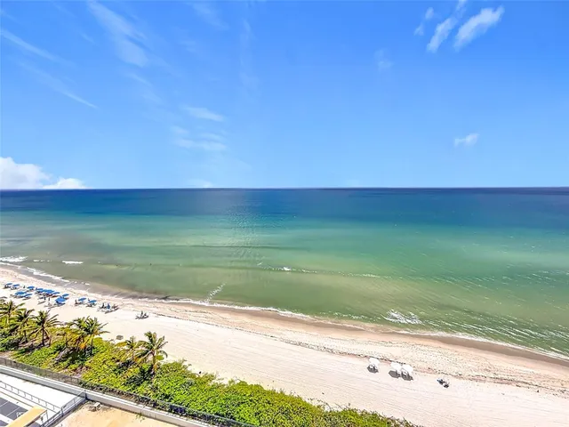 a kitchen with kitchen island a table and chairs in it