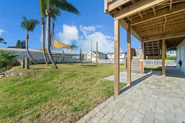 a view of a house with backyard and sitting area