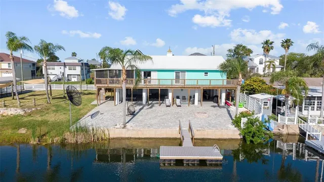 a view of a house with swimming pool and sitting area