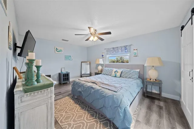 a bedroom with bed and a chandelier