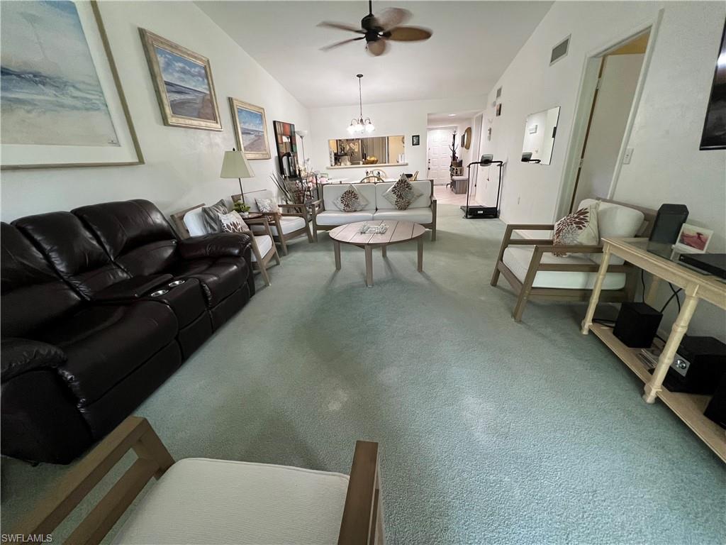 Undisclosed Address Naples, FL 34116 - Photo 14 of 14 a living room with furniture and a chandelier