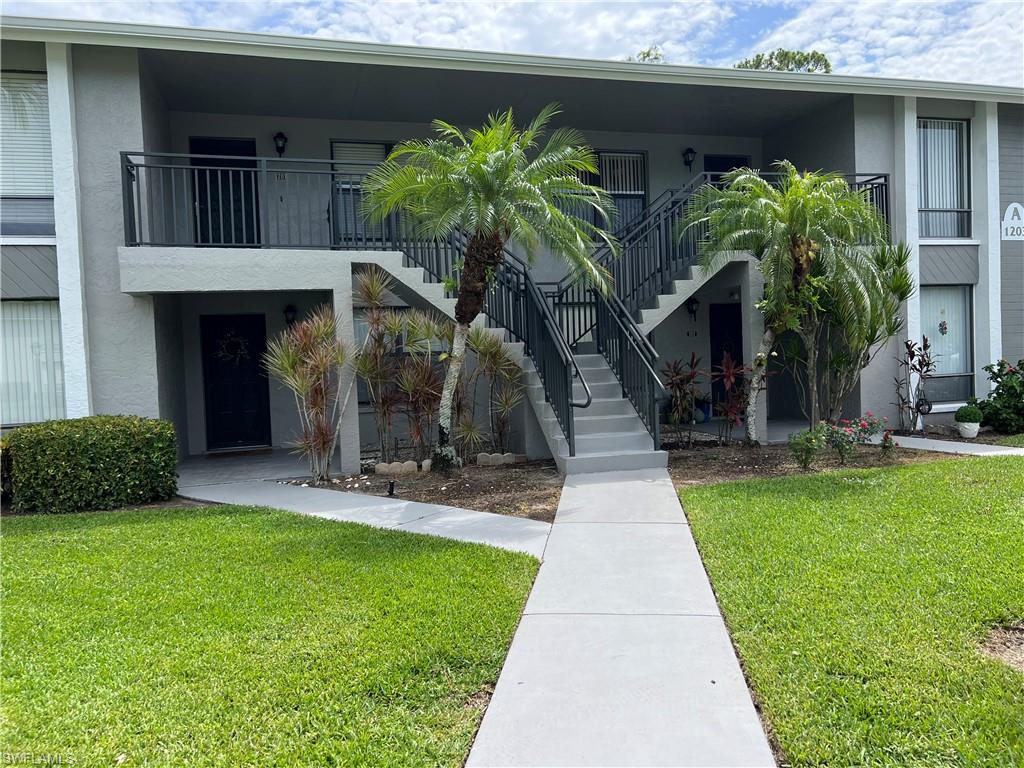 Undisclosed Address Naples, FL 34116 - Photo 2 of 14 a front view of a house with garden