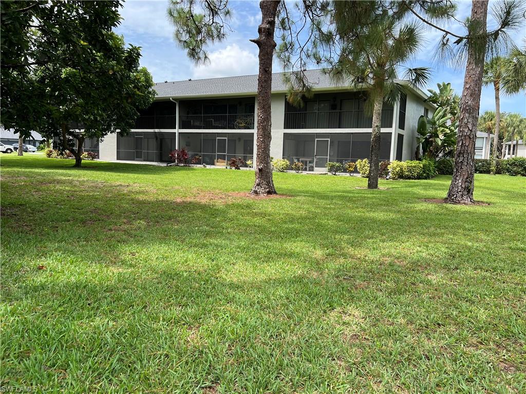 Undisclosed Address Naples, FL 34116 - Photo 6 of 14 a house view with swimming pool in front of it
