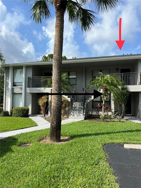 Undisclosed Address Naples, FL 34116 - Photo 7 of 14 a front view of a house with garden