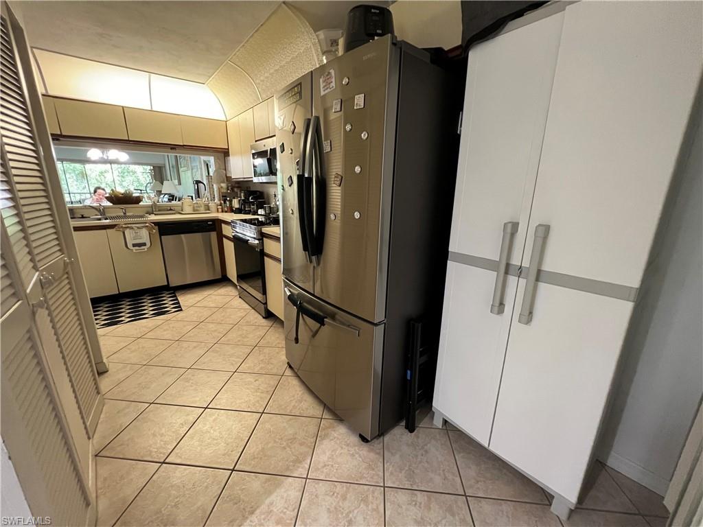 Undisclosed Address Naples, FL 34116 - Photo 8 of 14 a kitchen with a refrigerator a sink and cabinets