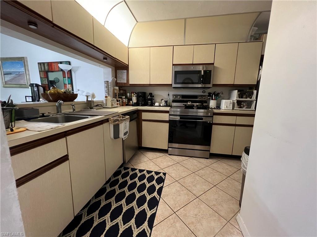 Undisclosed Address Naples, FL 34116 - Photo 9 of 14 a kitchen with stainless steel appliances a sink and a stove
