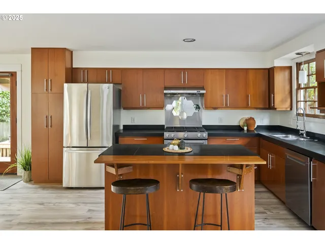 a kitchen with a refrigerator and a sink