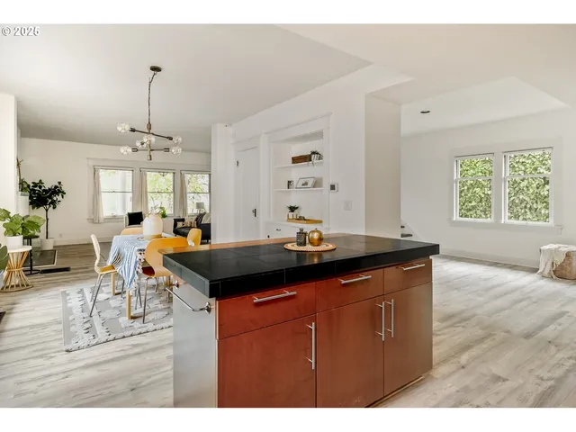 a kitchen with a stove and a dining table