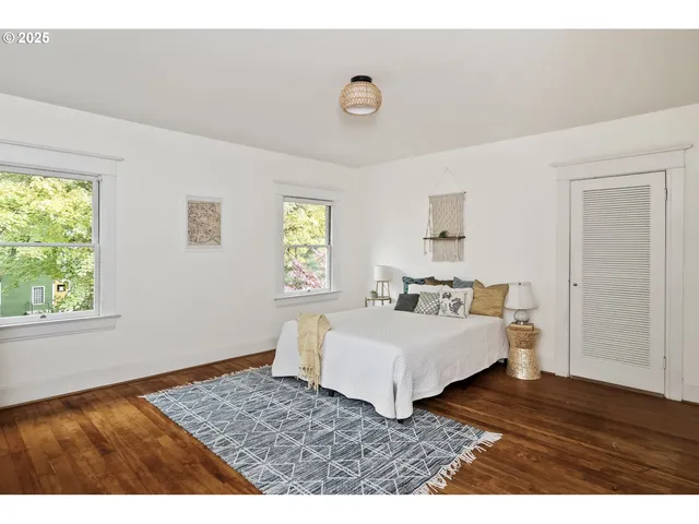 a living room with a bed furniture and a window