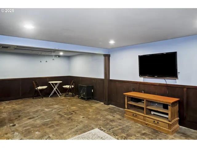 a room with furniture and a flat screen tv