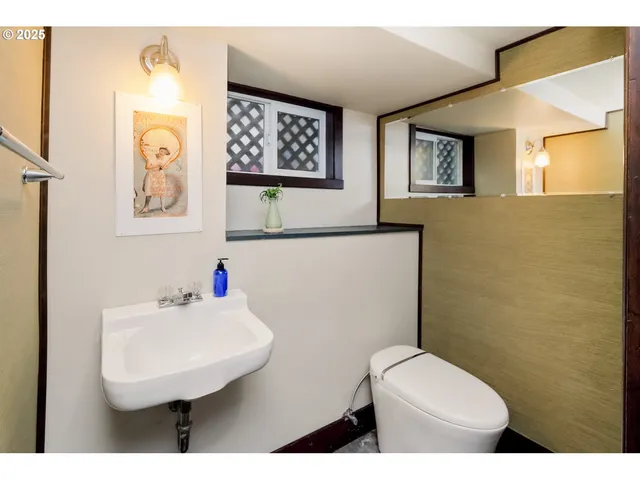 a bathroom with a toilet sink and mirror