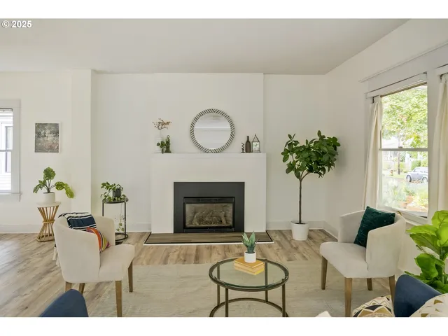 a living room with furniture a potted plant and a fireplace