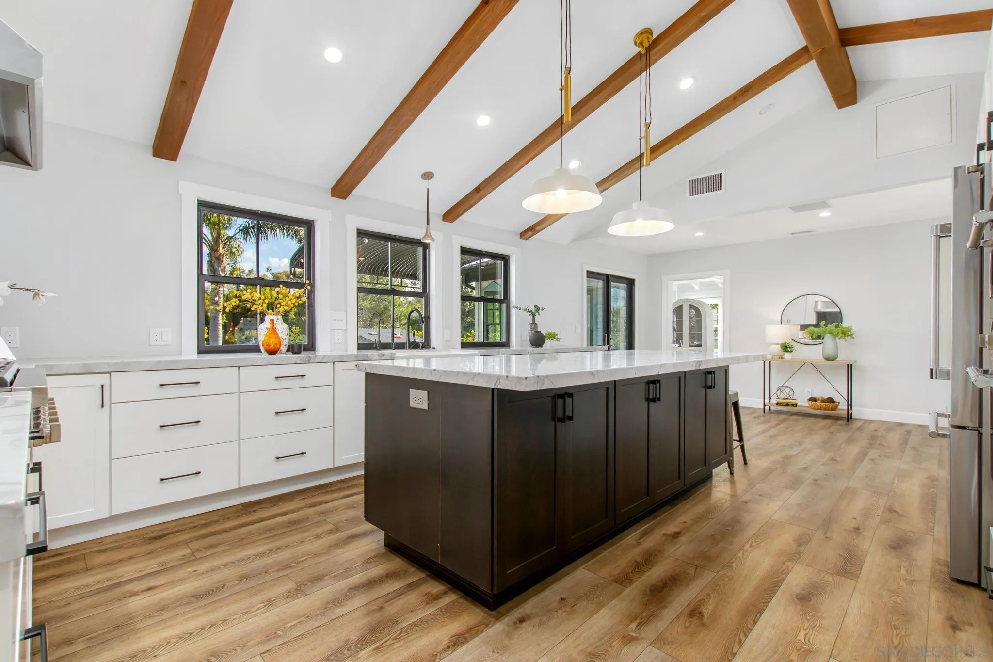 2335 Ivy Road Oceanside, CA 92054 - Photo 17 of 53 a kitchen with stainless steel appliances granite countertop a lot of counter space and wooden floors