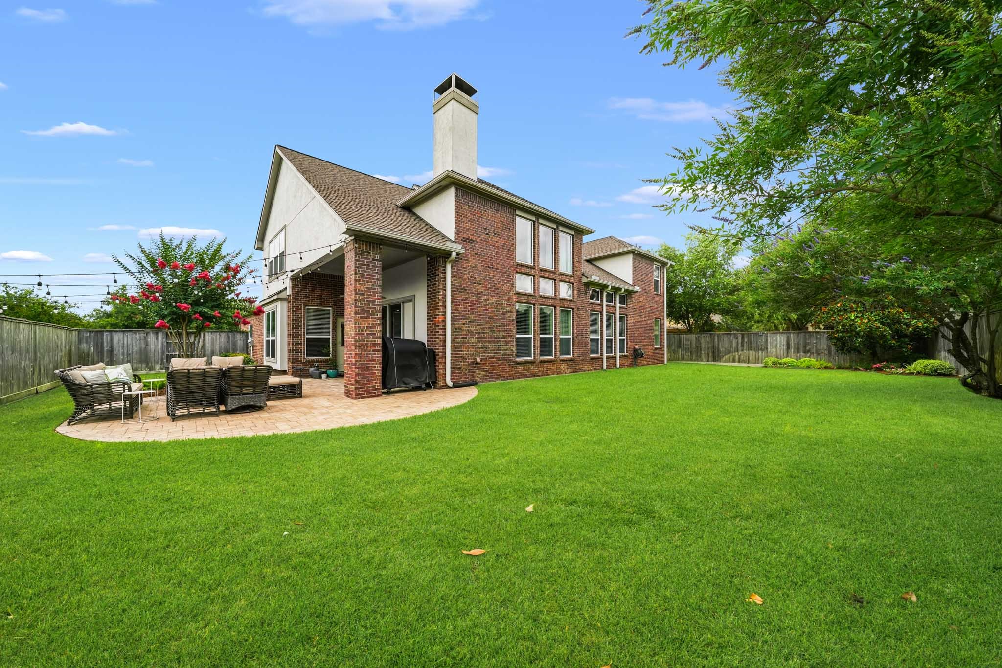 17610 Strackfield Lane Tomball, TX 77377 - Photo 46 of 50 Vibrant landscaping, mature trees, and expansive green space transform the backyard into a secluded space where beauty, privacy and Texas outdoor living come together effortlessly.