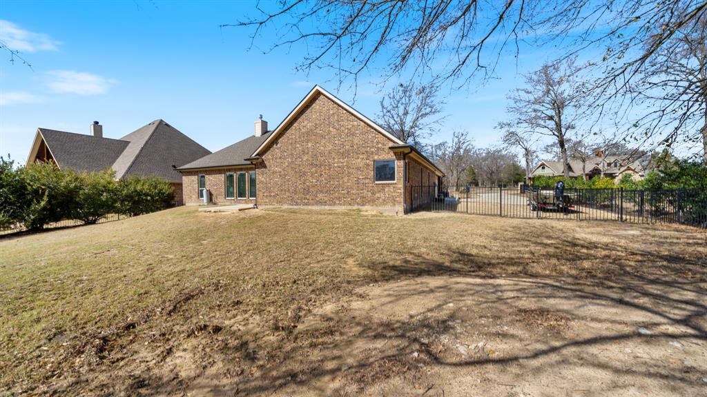 101 Lighthouse Lane Mabank, TX 75143 - Photo 28 of 40 Rear view of property featuring brick siding and a chimney