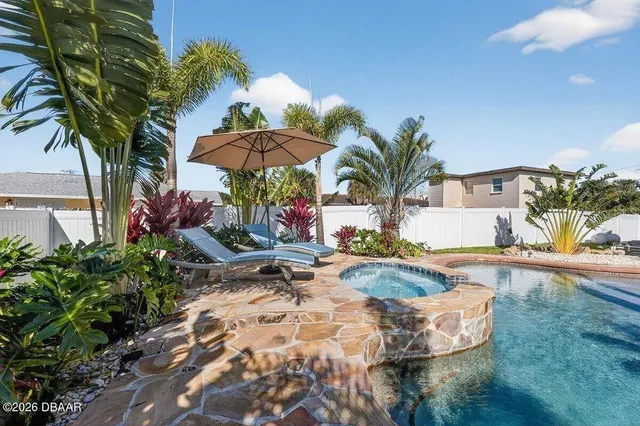 a view of a backyard patio and swimming pool