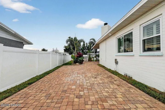 a house with potted plants in front of it