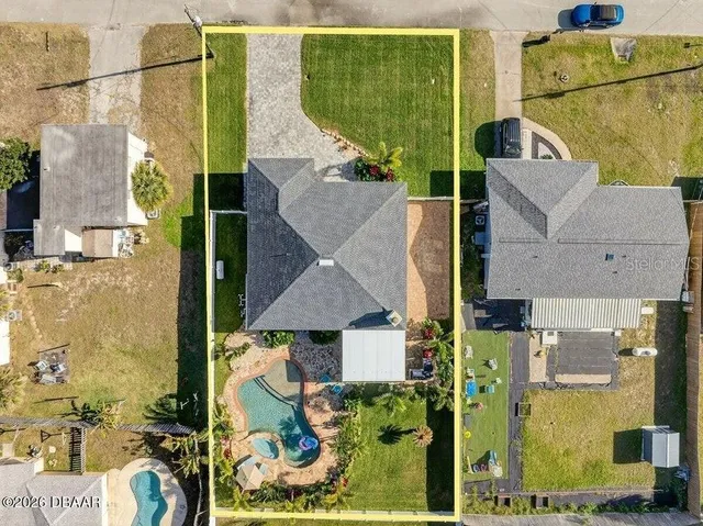 an aerial view of residential houses with outdoor space