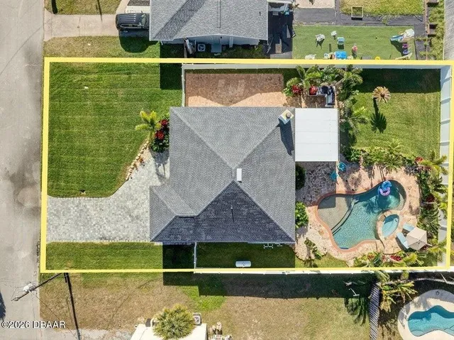 an aerial view of house with yard swimming pool and outdoor seating