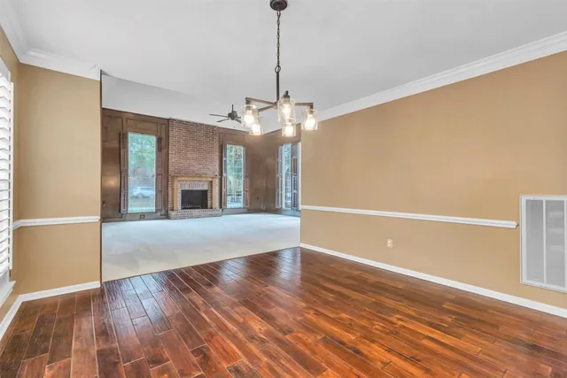 a view of a kitchen with a sink and chandelier