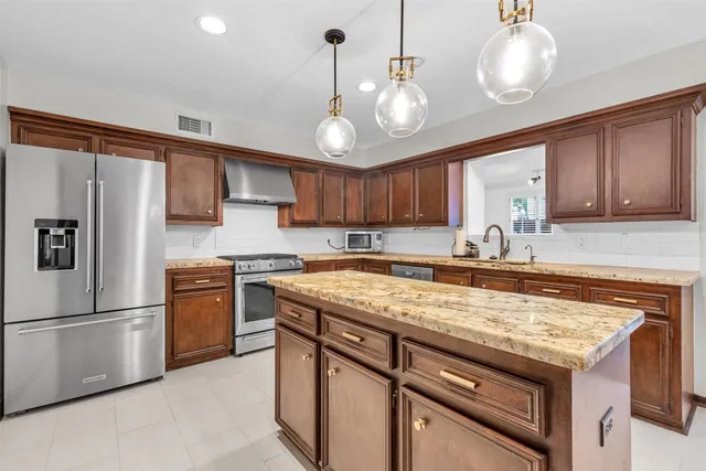 a bathroom with a granite countertop sink and shower