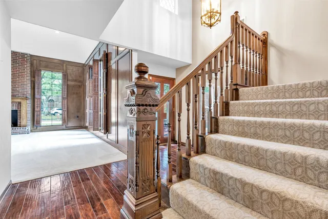 a view of a livingroom with wooden floor and a ceiling fan