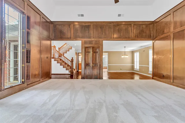 a large kitchen with stainless steel appliances kitchen island granite countertop a stove a sink a refrigerator and a view of living room