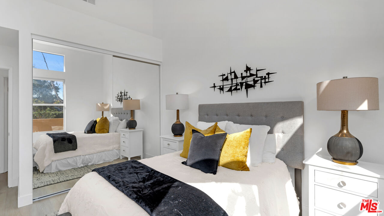 19431 Rue De Valore, Unit 41M Foothill Ranch, CA 92610 - Photo 11 of 23 a bedroom with a bed and wooden floor