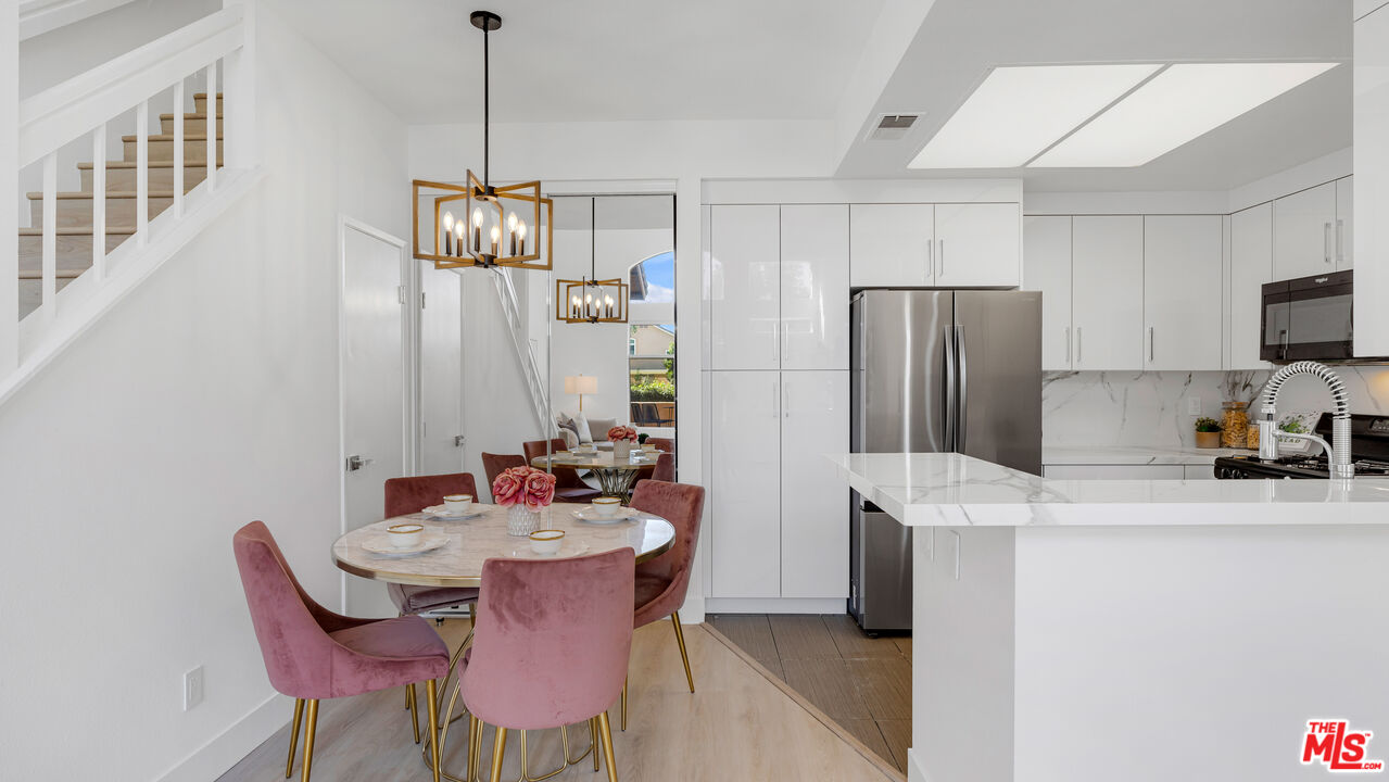 19431 Rue De Valore, Unit 41M Foothill Ranch, CA 92610 - Photo 5 of 23 a kitchen with stainless steel appliances a dining table chairs and a refrigerator