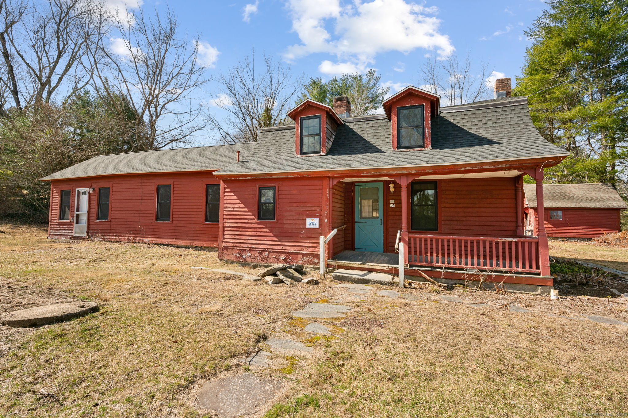 front view of a house with a yard and garage