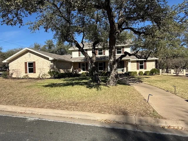 a view of a house with snow on the road