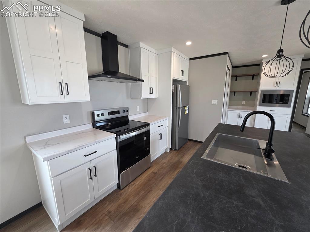 6685 Ramah Highway Yoder, CO 80864 - Photo 11 of 30 a kitchen with white cabinets stainless steel appliances and sink