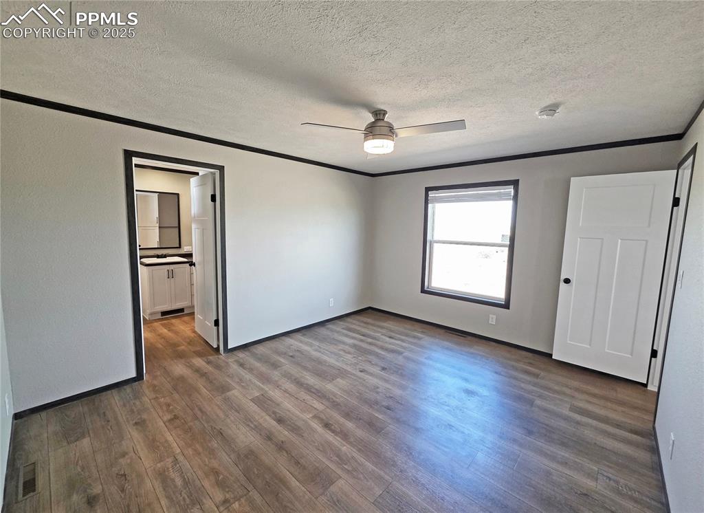 6685 Ramah Highway Yoder, CO 80864 - Photo 15 of 30 an empty room with wooden floor and windows